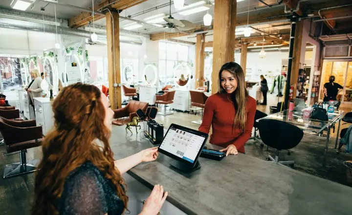 Customer paying at a shop counter